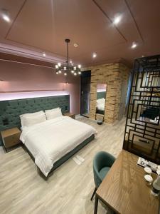a bedroom with a bed and a chair and a table at Ardenica Boutique Hotel in Lushnjë +111 photos
