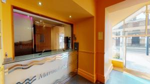 a bathroom with orange walls and a large window at Marine Lodge in Great Yarmouth