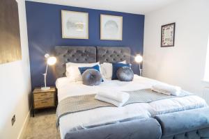 a bedroom with a large bed with blue walls at Nap Bristol City Centre in Bristol