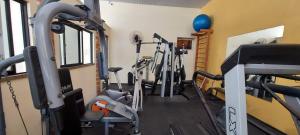 a gym with several tread machines in a room at Fortaleza Flat Executivo in Fortaleza +7 photos