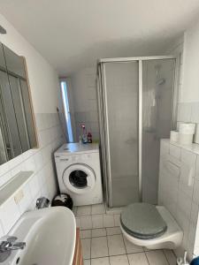 a bathroom with a washing machine and a washer at Schickes 2 Zimmer-Cityapartment Bielefeld Mitte in Bielefeld