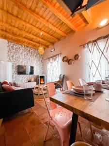 a living room with a wooden table and chairs at Apartamentos Vista Sierra Nevada in Sierra Nevada