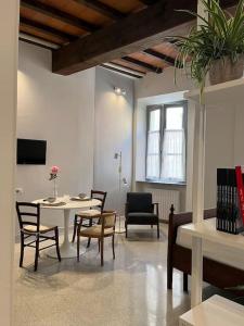 a living room with a table and chairs at XX Settembre Studio Apartment in Parma