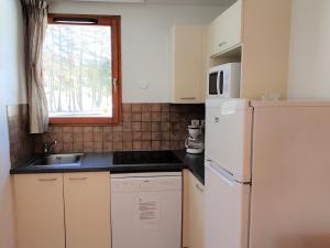 a small kitchen with a sink and a refrigerator at Chalet Le Dévoluy, 3 pièces, 6 personnes - FR-1-504-493 in Superdevoluy