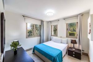 a bedroom with a bed and two windows at Harmonia Beach Villa in Mavroli +50 photos