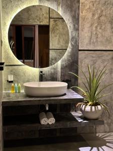 a bathroom with a sink and a mirror at Ami Mirissa in Mirissa