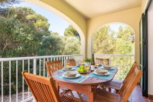 a dining room with a table and chairs on a balcony at SolParc 589 in Son Parc