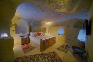 A bed or beds in a room at Babili Cappadocia Cave