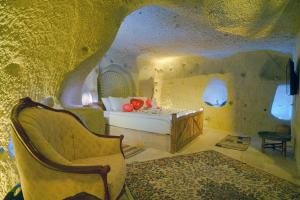 A bed or beds in a room at Babili Cappadocia Cave