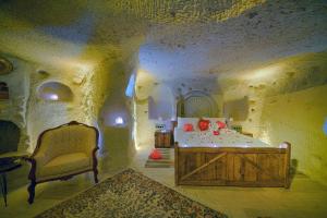 A bed or beds in a room at Babili Cappadocia Cave