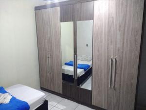 a large wooden cabinet with two beds in a room at Casa Morumbi Foz do Iguaçu in Foz do Iguaçu