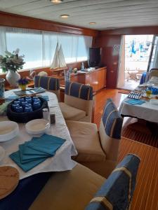 a room with a table and chairs in a boat at Yatch Nelly Blue Rome in Lido di Ostia