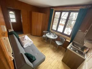 a living room with a couch and a table at Willa Konradówka - apartamenty Dębowy, Klonowy, Kosówka, Limba i Brzozowy in Zakopane +52 photos