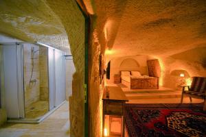 A bed or beds in a room at Babili Cappadocia Cave
