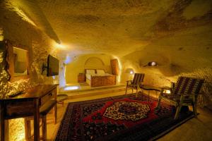 A bed or beds in a room at Babili Cappadocia Cave