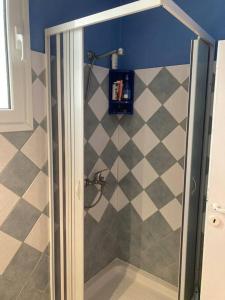 a shower with a glass door in a bathroom at Granatapfel in Porto Heli