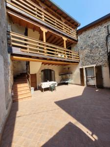 a large patio with a wooden deck on the side of a building at La Casa sull' Altopiano Mountain Lake Iseo hospitality in Bossico