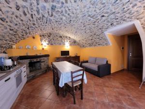 a kitchen with a table and a dining room at La Casa sull' Altopiano Mountain Lake Iseo hospitality in Bossico