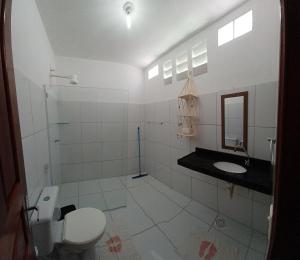 a bathroom with a toilet and a sink at Manitu Flat Canoa Quebrada in Canoa Quebrada +53 photos