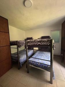 a room with two bunk beds in a room at Casa Machtiani in Xicotepec de Juárez