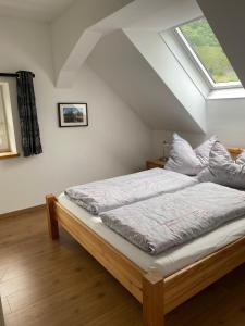 a bedroom with a bed with pillows and a window at Haus Auszeit in Rauris
