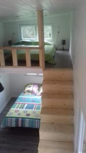 a staircase leading to a bedroom with a bunk bed at Tiny House JOY in Beulotte-Saint-Laurent