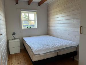 a bedroom with a bed and a window at Hovborg Ferieby - Torpet 126 in Hovborg
