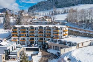 an aerial view of a hotel in the snow at Ski- & Sonnenresort Alpendorf by AlpenTravel in Sankt Johann im Pongau