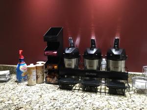 a group of coffee makers sitting on a counter at Red Roof Inn & Suites Commerce - Athens in Commerce