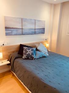 a bedroom with a large bed with two pillows on it at El Solarón in Gijón