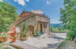 an external view of a stone house with a patio at Valle Dame in Cortona