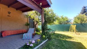 a patio with a bench and flowers in a yard at La Ernestina in Villa Giardino