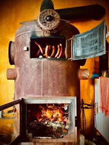 a oven with a bunch of bacon cooking in it at HARABURDI® Recyclart Hotel in Kostelec nad Orlicí