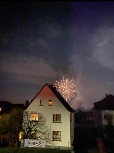a firework display in the sky above a house at Ferienwohnung im Garten Eden in Grünberg