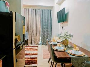 a dining room with a table and chairs in a room at Homey-feel Studio Unit @ Lafayette Park Square Condominium in Iloilo City