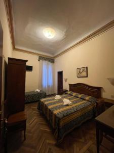 a hotel room with a bed and a table at Hotel Alla Fava in Venice