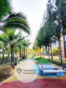 a park in the middle of a park with palm trees at Timurbay Seafront Residence byDiamond Studio Suites 1 plus 1 in Kuantan