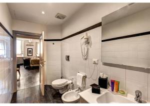 a bathroom with a toilet and a sink at Suites Giulia in Rome +46 photos