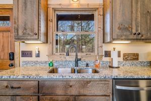 a kitchen with a sink and a window at Rustic Retreat in Ellijay +45 photos