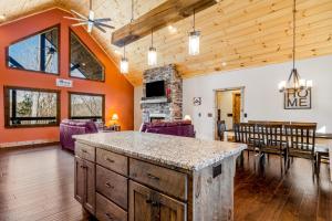 a kitchen and dining room with a table and chairs at Rustic Retreat in Ellijay