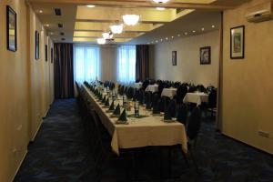 a conference room with a long table with chairs at Hotel Club in Kežmarok