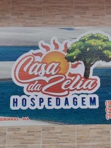a sign for a coca cola hosseinocemetery istg at Casa da Zélia Hospedagem in Barreirinhas