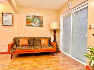 ein Wohnzimmer mit einem orangenen Sofa und einem Fenster in der Unterkunft Chic Chalet River Views & Access 