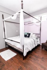 a bedroom with a bed with a metal canopy at 1 BR, Dorado beach apartment 20% monthly discount in Dorado