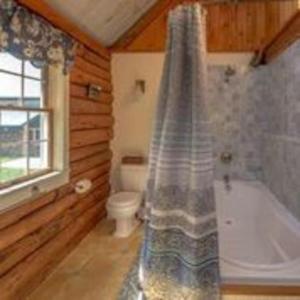 a bathroom with a shower and a tub and a toilet at Big Sky Mountain Estate in Brownfield