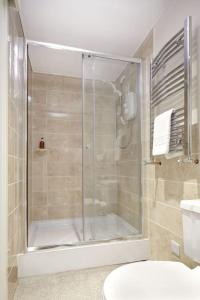 a bathroom with a shower and a toilet at Bush Nook Farmhouse in Brampton