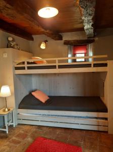 two bunk beds in a room with a red rug at Maison d'hôtes De La Boissière in Andillac +39 photos
