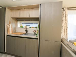 a kitchen in a tiny house with a sink at Hollybirch in Crieff