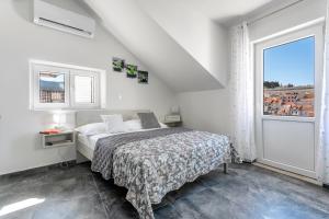 a bedroom with a bed and a large window at Sea view from the center of Hvar in Hvar