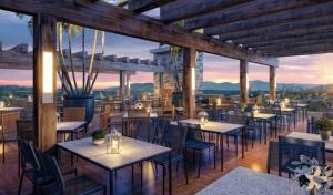 a restaurant with tables and chairs with a view at Quarto familia Golden Gramado Resort Laghetto in Gramado